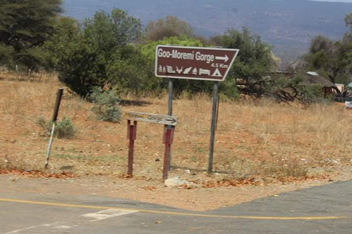 Traveyola Goo Moremi Gorge Sign on the road, Moremi, Botswana